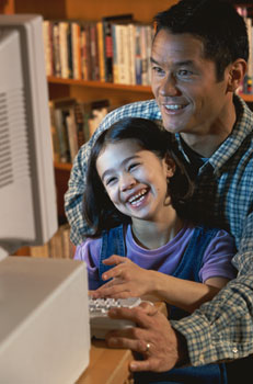 Man and daughter on home computer - Home IT consulting services for your home network issues